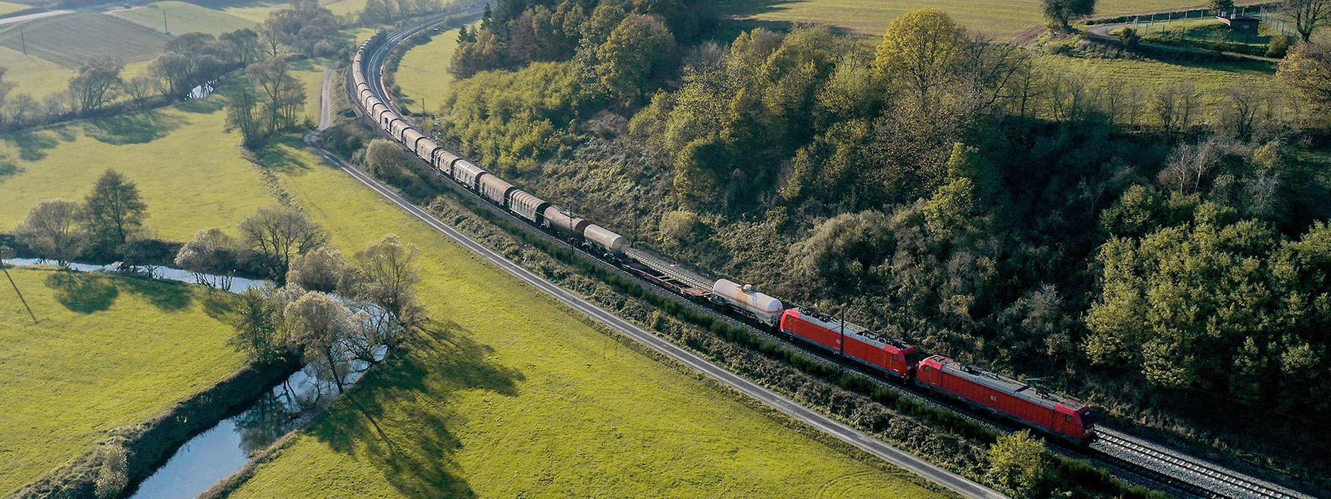 Long freight train in beautiful landscape.