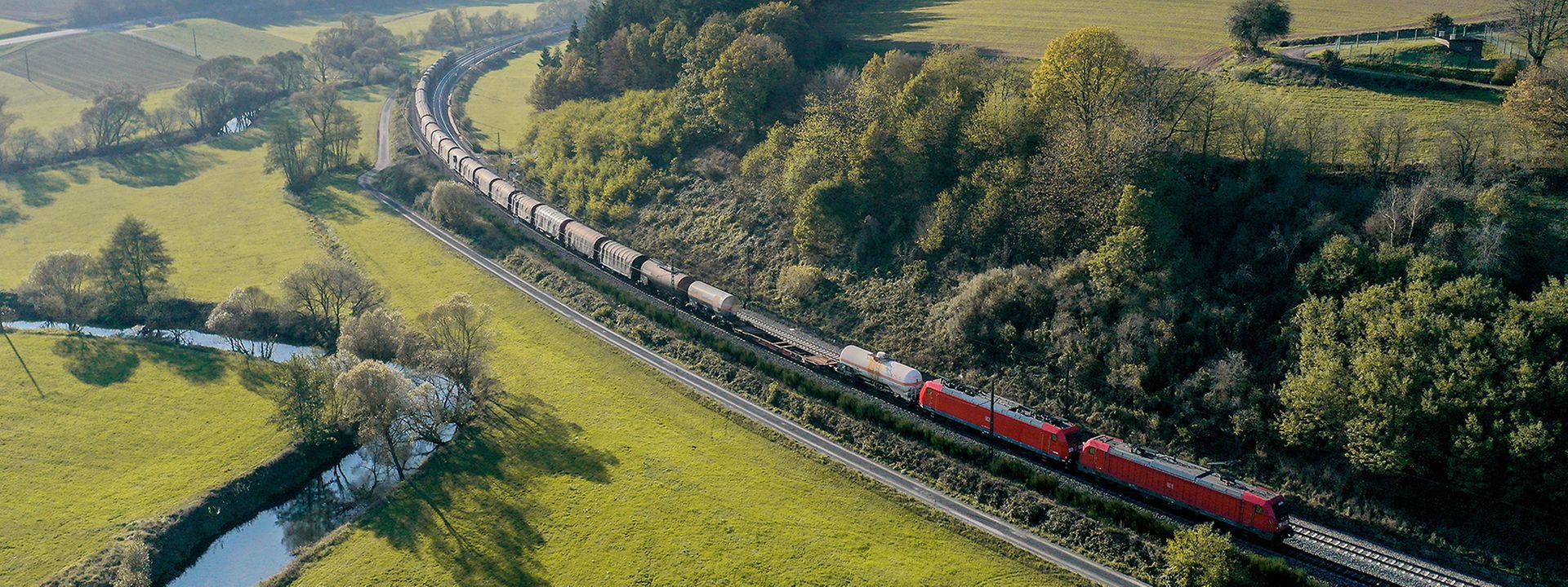 Long freight train in beautiful landscape.